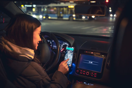 Driving a car at night, a woman driving her modern car at night in the city.