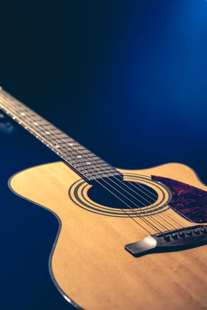 Musical background with acoustic guitar close up.