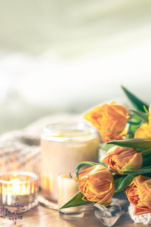 Spring background with yellow tulips, candles and knitted element.の写真素材