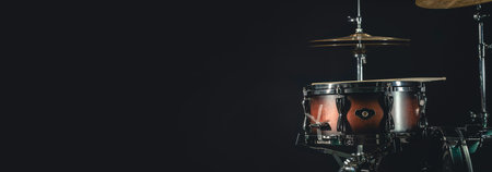 Snare drum on a dark background isolated with space for a text.