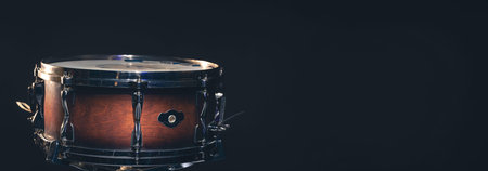 Snare drum on a dark background isolated with space for a text.
