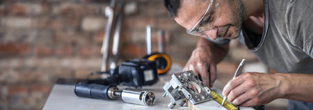 A carpenter in the process, a professional tool for precision drilling in wood.