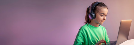 Funny little girl in headphones with laptop plays games, game addiction concept.