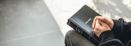 Close-up, holy Bible book in male hands.
