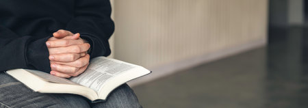 Close-up, holy Bible book in male hands.の写真素材