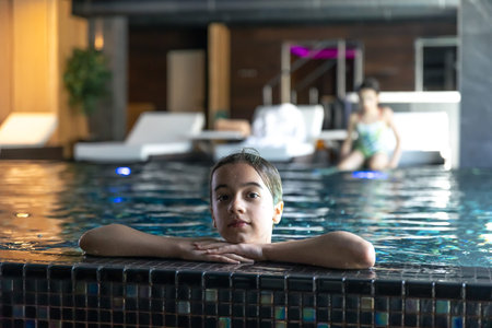 Portrait girl having fun in indoor swimming pool.