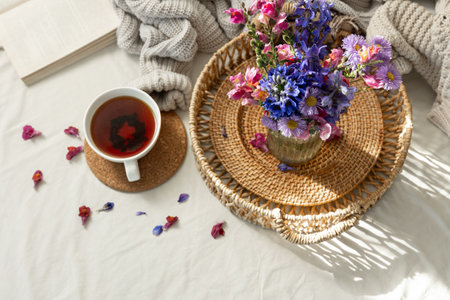Still life with a cup of tea and a bouquet of wildflowers in a home interior.の写真素材