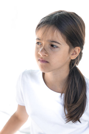 Sad, dissatisfied or disappointed teenage girl on a white background.