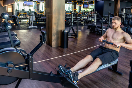 The athlete does exercises on the mushroom simulator in the gym.Sports lifestyle