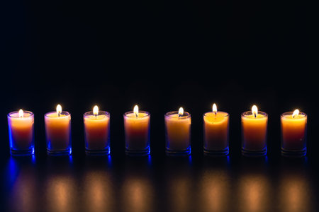 Burning candle on black background with backlight. Memorial Day.の写真素材