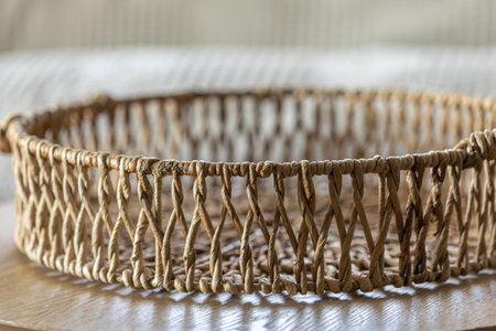 Round wicker basket on the table. Wicker basket in the interior close-up.の写真素材