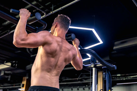 Athlete doing push-ups in the gym with a bare torso. Sport lifestyle.の写真素材