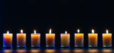 Burning candle on black background with backlight. Memorial Day.の写真素材