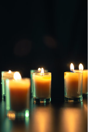 Burning candle on black background with backlight. Memorial Day.の写真素材