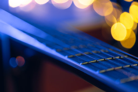 Part of an guitar fretboard on a black background.の写真素材