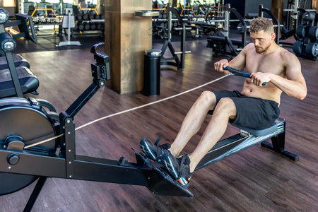 The athlete does exercises on the mushroom simulator in the gym.Sports lifestyleの写真素材