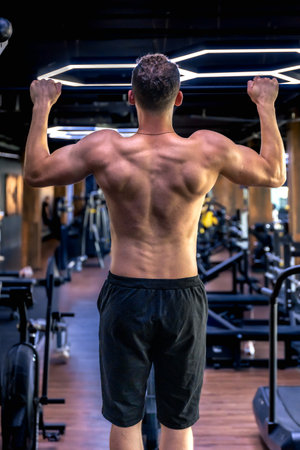 Back view of a man doing push-ups in the gym. Sports lifestyle.の写真素材