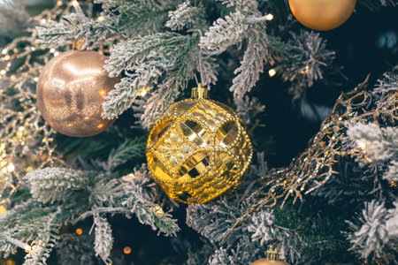 Close-up, golden ball on a Christmas tree close-up.の写真素材