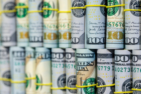 Close-up of twisted 100 dollar bills. Finance concept background.の写真素材