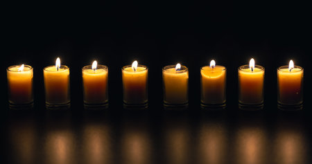 Burning candle on black background with backlight. Memorial Day.の写真素材