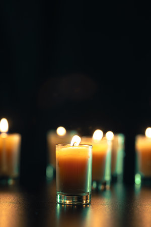 Burning candle on black background with backlight. Memorial Day.の写真素材
