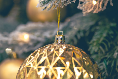 Close-up, golden ball on a Christmas tree close-up.の写真素材