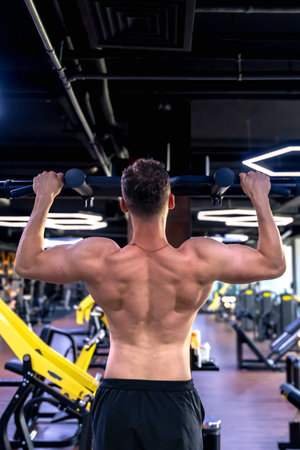 Back view of a man doing push-ups in the gym. Sports lifestyle.の写真素材