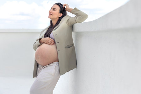 Stylish pregnant woman wearing a jacket. Concept of style and pregnancy.の写真素材