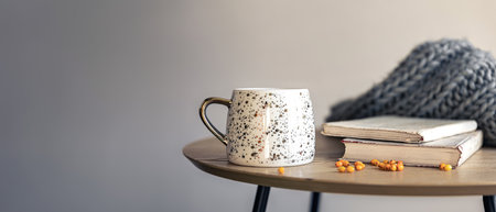 Autumn home atmosphere. Autumn composition with a cup and books.の写真素材