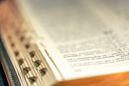 Open Bible on a black background. Religion concept. Bible pages close-up.