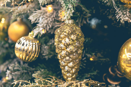 Gold Christmas decorations on the Christmas tree close-up.の写真素材