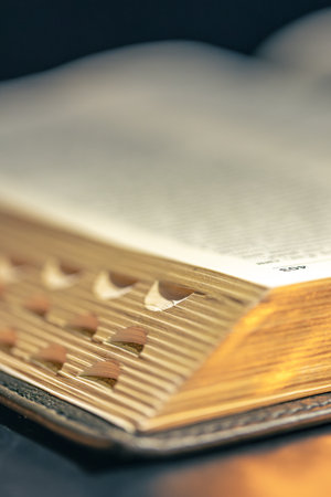 Open Bible on a black background. Religion concept. Bible pages close-up.の写真素材