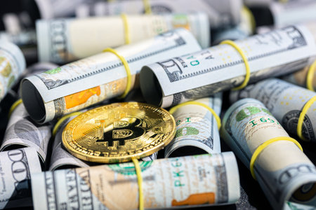 Bitcoin coin with 100 dollar bill. Concept of finance background close-up.の写真素材