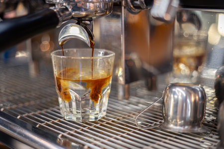 Making coffee by a barista in a coffee machine. The coffee machine makes coffee.の写真素材