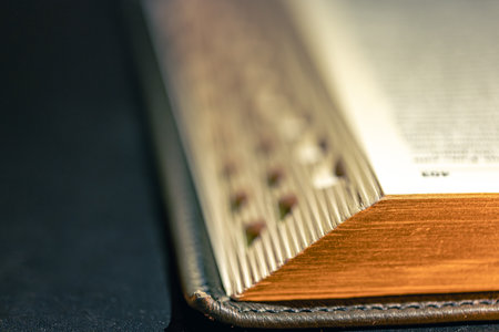 Open Bible on a black background. Religion concept. Bible pages close-up.の写真素材