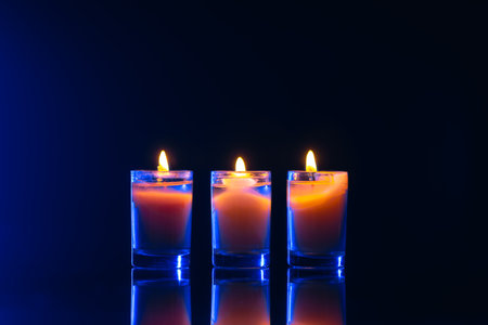 Burning candle on black background with backlight. Memorial Day.の写真素材