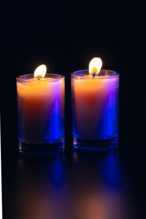 Burning candle on black background with backlight. Memorial Day.の写真素材