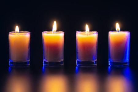 Burning candle on black background with backlight. Memorial Day.の写真素材