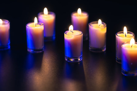 Burning candle on black background with backlight. Memorial Day.の写真素材