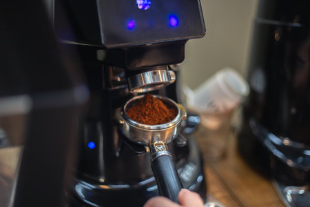 Barista grind coffee bean with grinder machine. The barista prepares coffee.の写真素材
