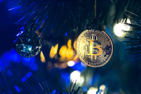 Bitcoin coin on christmas tree with bokeh lights. Finance concept.の写真素材