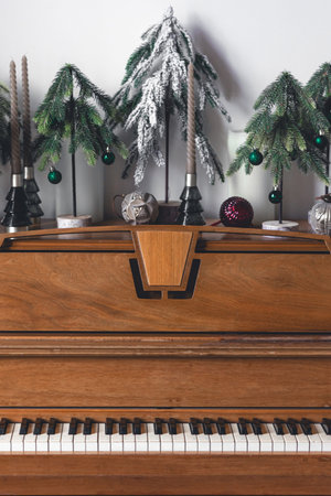 Wooden piano in an interior decorated for Christmas.