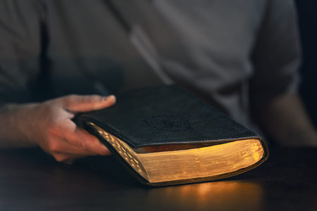 A man holds a Bible in his hands.