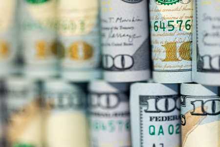 Close-up of twisted 100 dollar bills. Finance concept background.