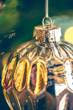 Christmas tree decoration close up, ball bauble in pine branches background.の写真素材