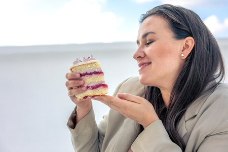 Pregnant woman with a cake in her hands. Concept of style and pregnancy.の写真素材