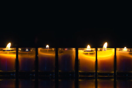 Burning candle on black background with backlight. Memorial Day.の写真素材