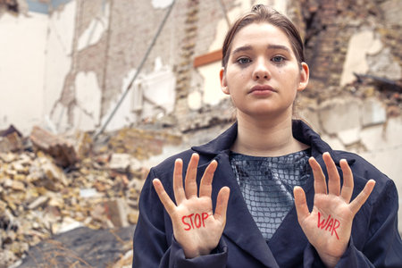 Slogan of peace without war is written on the womans hand in red stop war.の写真素材