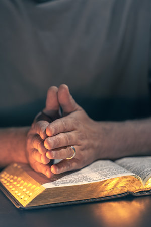 A man reads the Bible. Male hands with Bible close-up.の写真素材