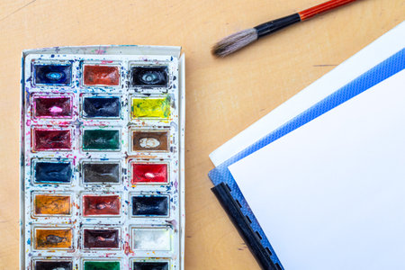 Palette with watercolors. A palette with watercolors and paint brush.の写真素材